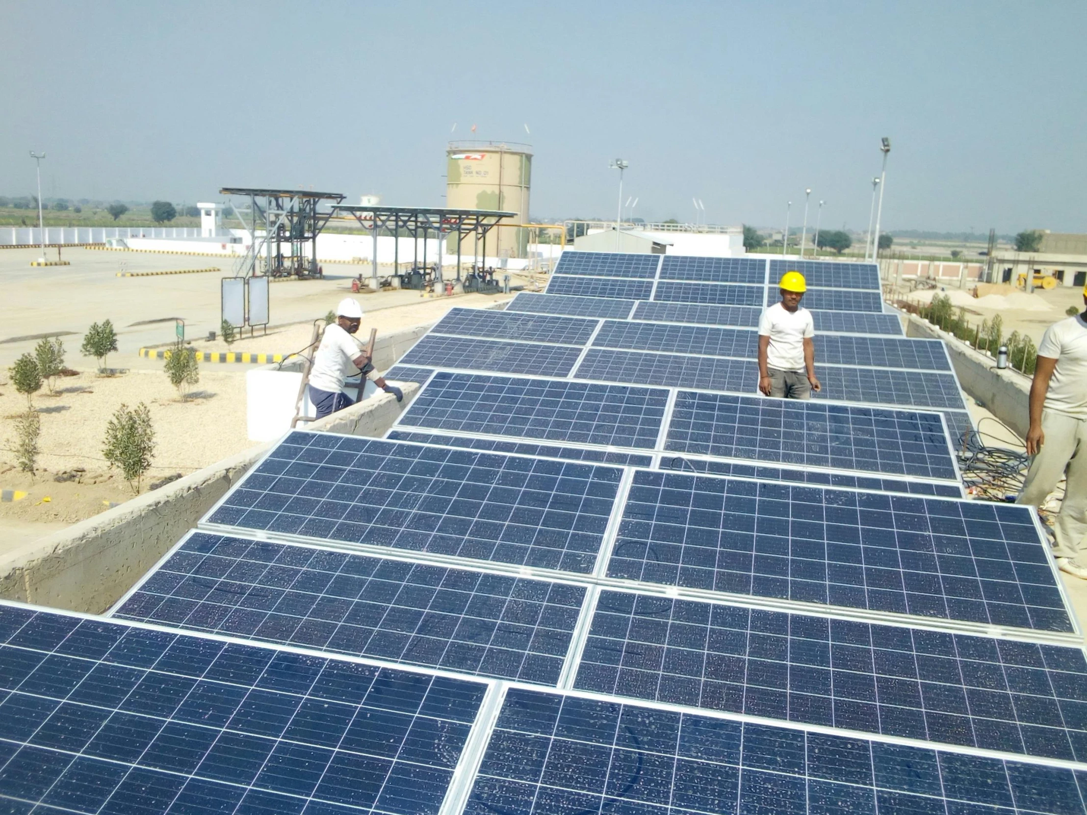 workers install solar panels on the roof of a building, by Xul Solar, flickr, bauhaus, india, in egypt, fujifilm”