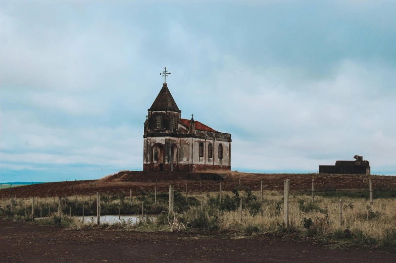 an old church in the middle of a field, pexels contest winner, nadav kander, built on a small, well preserved, brown