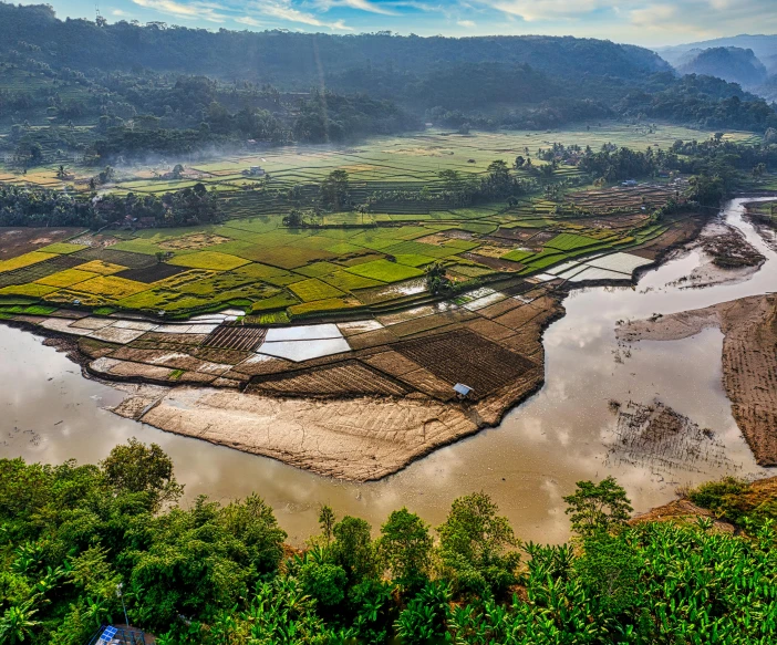 a river running through a lush green valley, by Joseph Severn, pexels contest winner, sumatraism, wide view of a farm, assamese aesthetic, thumbnail, overlooking