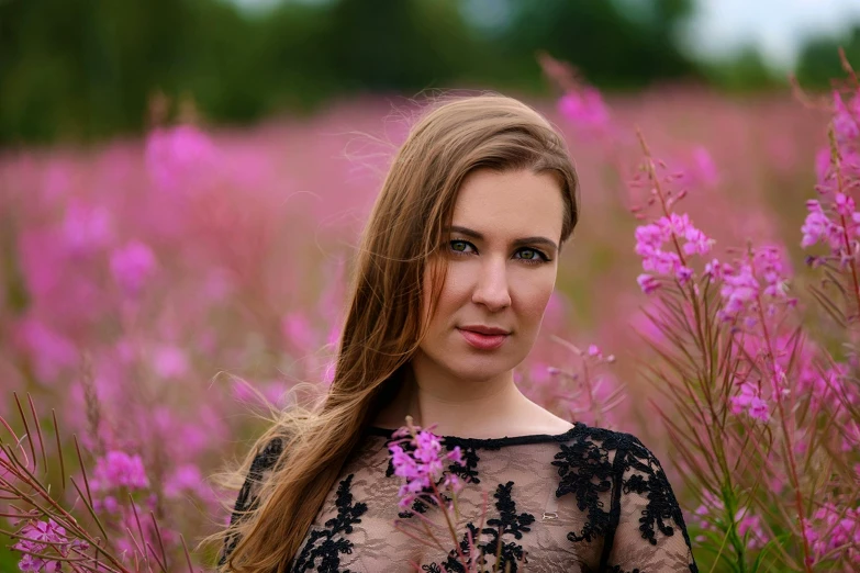 a woman standing in a field of purple flowers, a portrait, by Zofia Stryjenska, pexels contest winner, pink grass, avatar image, portrait image, 3 / 4 view portrait