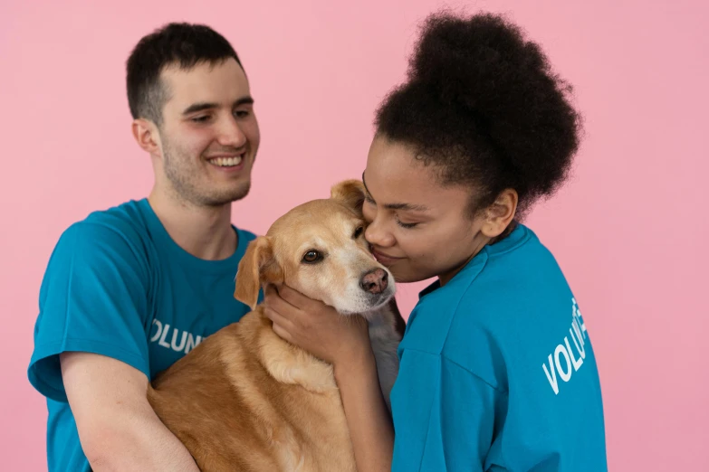 a man and woman holding a dog in front of a pink background, profile image, pokimane, brown and cyan color scheme, a friend in need