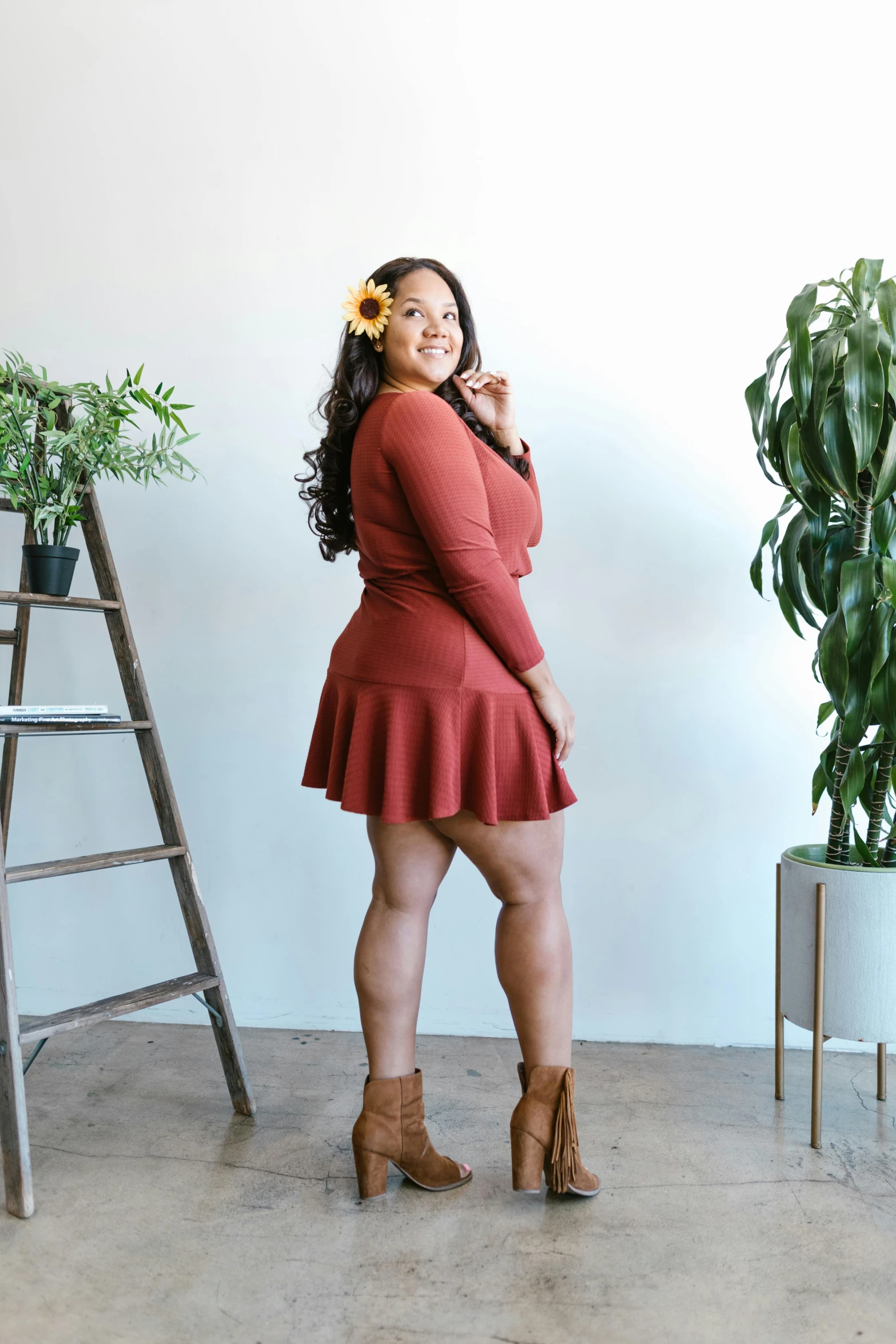 a woman standing in a room next to a ladder, featured on instagram, skater skirt, terracotta, curvy and bow, profile image