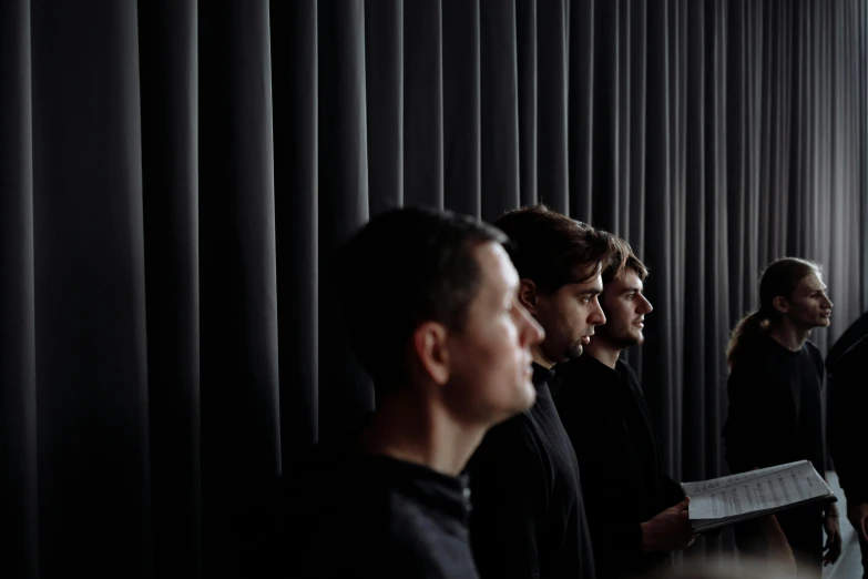 a group of people standing next to each other, an album cover, by Tobias Stimmer, unsplash, purism, vantablack cloth technology, looking from side, 3 actors on stage, near a window