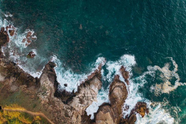 an aerial view of the ocean and rocks, pexels contest winner, intense emotion, manly, 8k resolution”, multiple stories