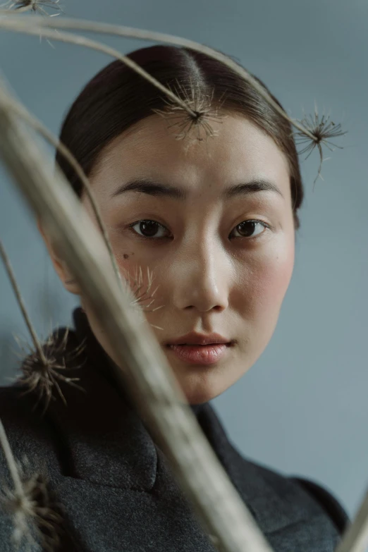 a close up of a person holding an umbrella, a character portrait, inspired by Kim Tschang Yeul, trending on pexels, hyperrealism, branches growing as hair, frown fashion model, ethnicity : japanese, portrait of an insectoid