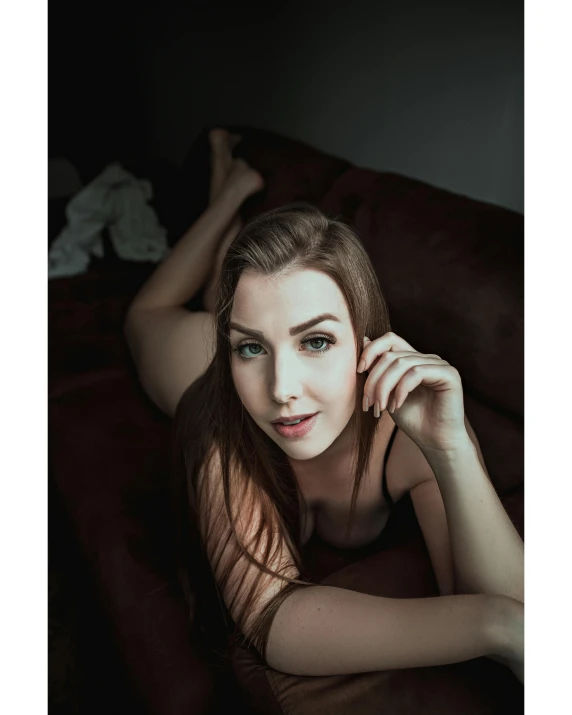 a beautiful young woman laying on top of a bed, inspired by Elsa Bleda, unsplash contest winner, 🤤 girl portrait, sitting on the couch, taken in the late 2010s, better known as amouranth