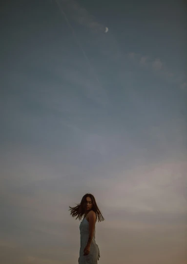 a woman standing on top of a beach next to the ocean, by Daniel Seghers, happening, medium format. soft light, looking up into the sky, flying hair, ((portrait))