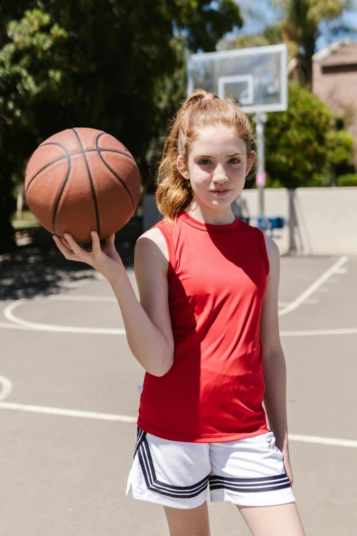 a girl holding a basketball on a basketball court, by Greg Spalenka, wearing red tank top, sydney sweeney, 15081959 21121991 01012000 4k, real life size