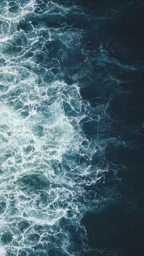 an aerial view of a body of water, an album cover, by Jacob Toorenvliet, pexels, hurufiyya, turbulent sea, trending on vsco, navy, instagram post