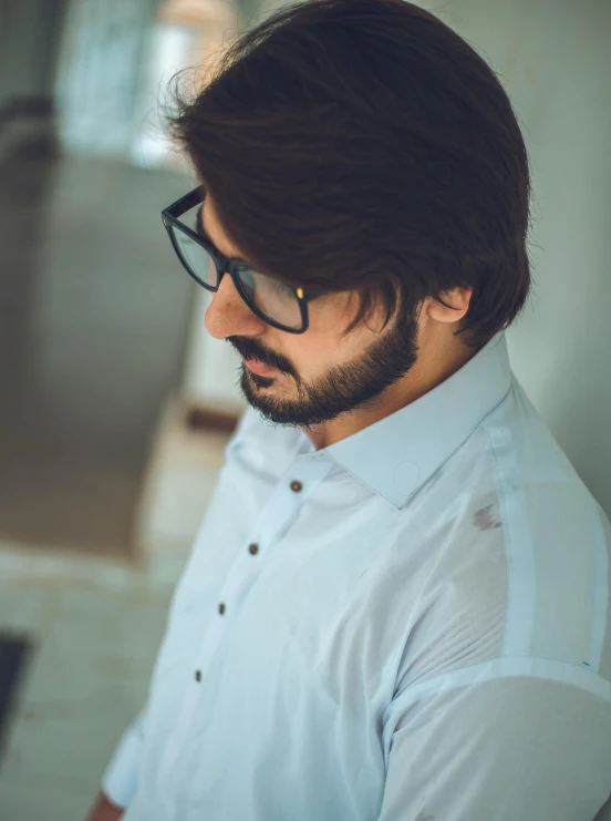 a man wearing glasses and a white shirt, inspired by Jitish Kallat, trending on unsplash, profile image, cinematic outfit photo, mid long hair, short goatee