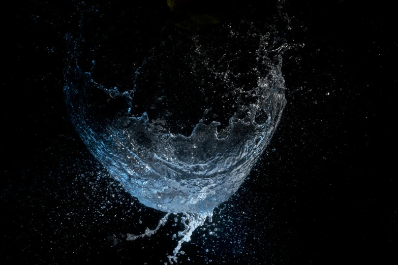 a close up of a glass of water on a table, an album cover, by Chris Rallis, pexels, conceptual art, magical glowing sphere in midair, against a deep black background, quixel mixer, dark blue water