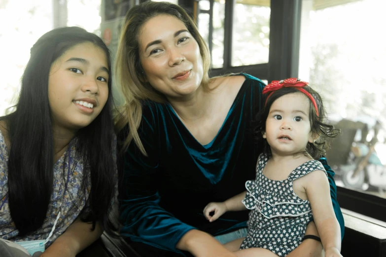 a woman and two young girls sitting next to each other, a portrait, by Judith Gutierrez, pexels contest winner, hurufiyya, leni robredo, 15081959 21121991 01012000 4k, small chin, hana alisa omer