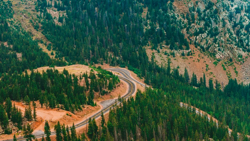 an aerial view of a winding mountain road, unsplash contest winner, trees and pines everywhere, idaho, 2 5 6 x 2 5 6 pixels, panoramic