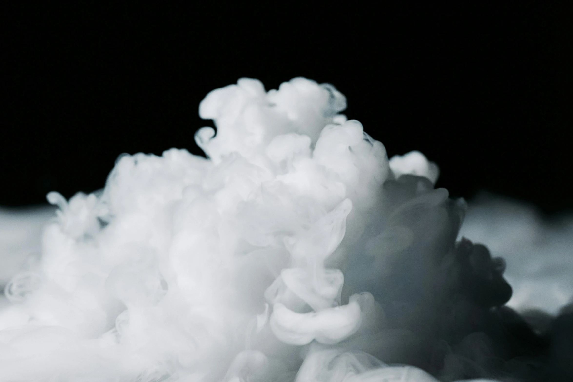 a pile of snow sitting on top of a snow covered ground, inspired by Kim Keever, unsplash, process art, underwater smoke, with a black background, puffy cute clouds, close-up product photo