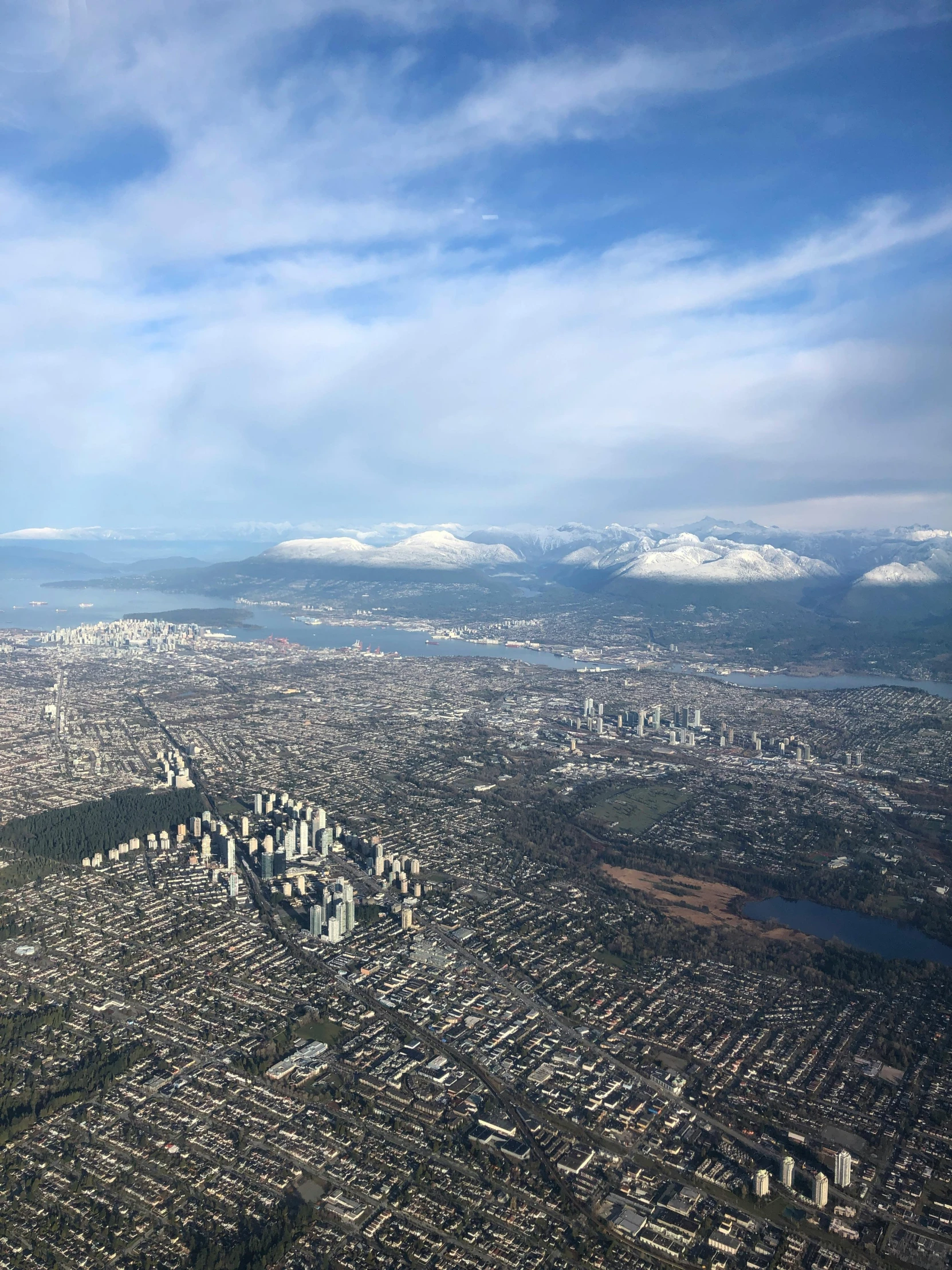 a view of a city from an airplane, by Dan Scott, reddit, vancouver school, snowy mountains, various posed, less detailing, 2 0 2 2 photo