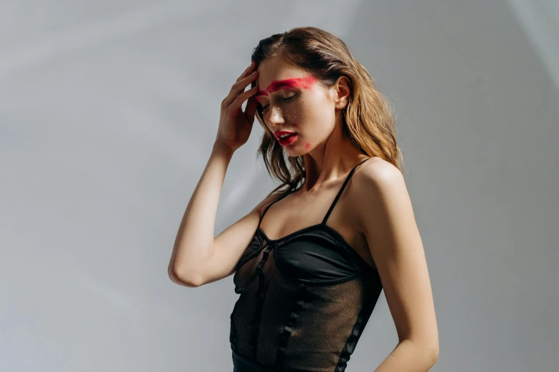 a woman in a black dress posing for a picture, an album cover, by Julia Pishtar, trending on pexels, red headband, latex outfits, fashion model face closed eyes, see - through