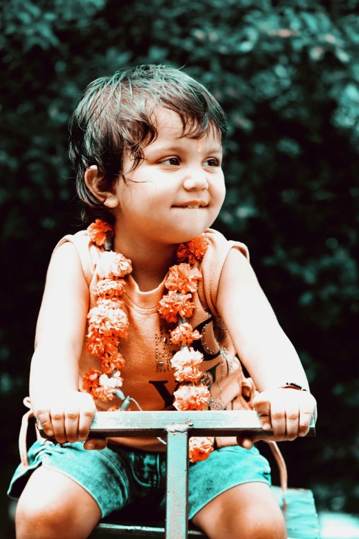 a young boy riding on the back of a tricycle, an album cover, inspired by Bapu, pexels contest winner, samikshavad, flowers on heir cheeks, she is smiling and happy, color film photography 1970s, profile picture 1024px