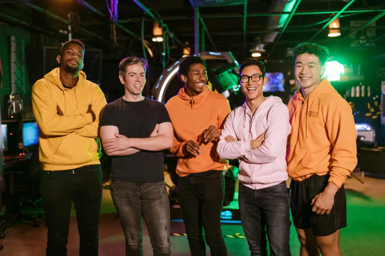 a group of men standing next to each other, neon basement, esports, dim dingy gym, lee madgwick & liam wong