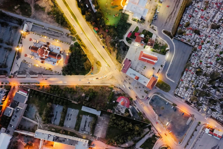 an aerial view of a city at night, by Adam Marczyński, pexels contest winner, photorealism, intersection, square, thumbnail, suburb