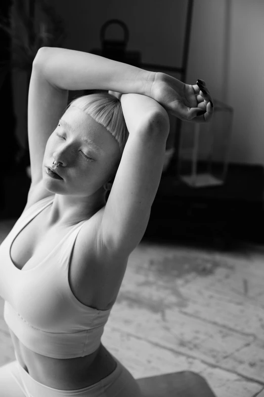 a black and white photo of a woman doing yoga, unsplash, realism, porcelain pale skin, armpit, bust, vivid