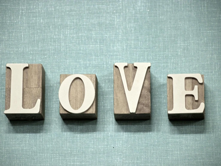 the word love spelled with wooden letters on a blue background, by Sylvia Wishart, letterism, wall paper, teal, cute photograph, panels
