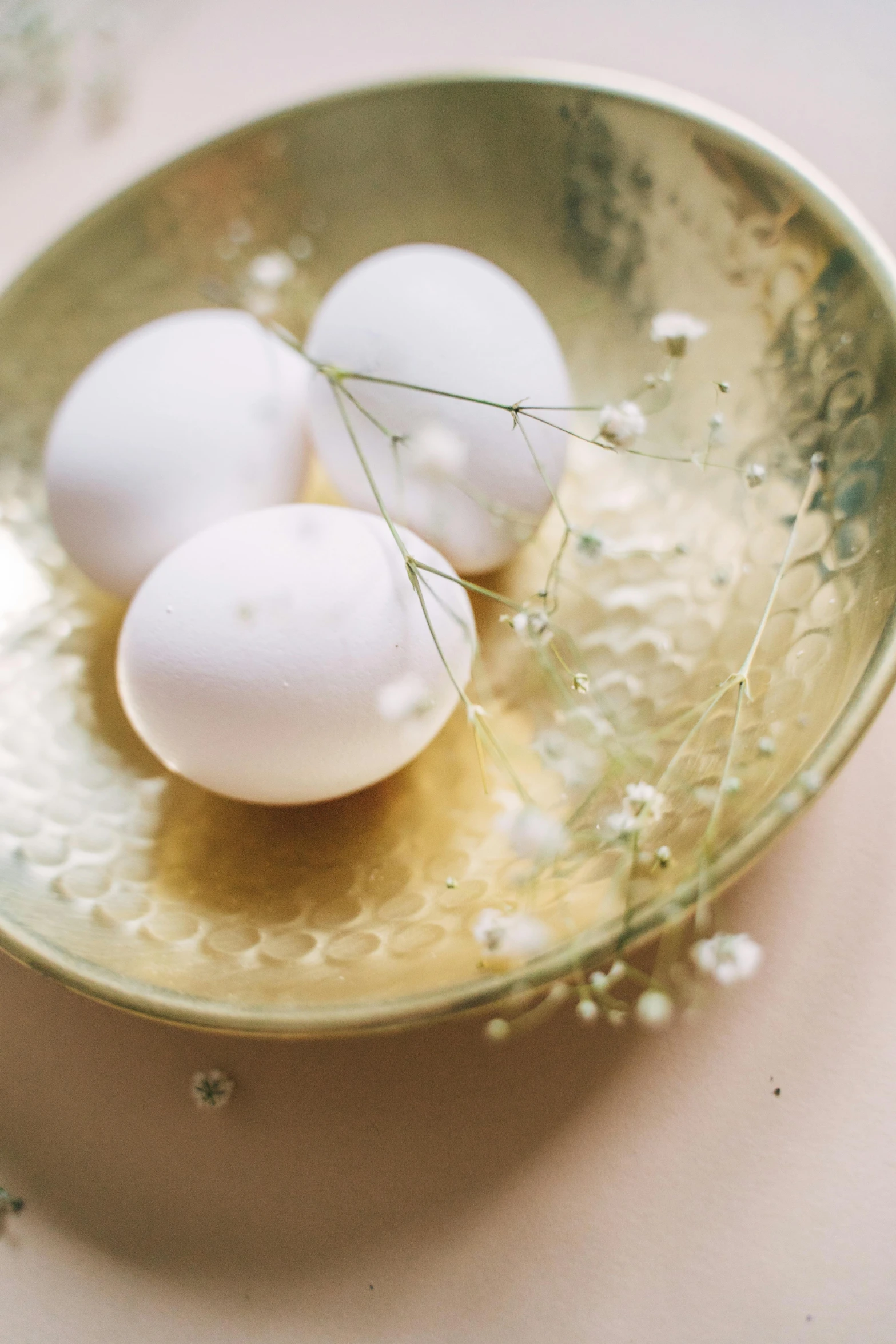 three eggs in a bowl on a table, trending on unsplash, renaissance, gold flaked flowers, soft beautiful light, cake, jasmine