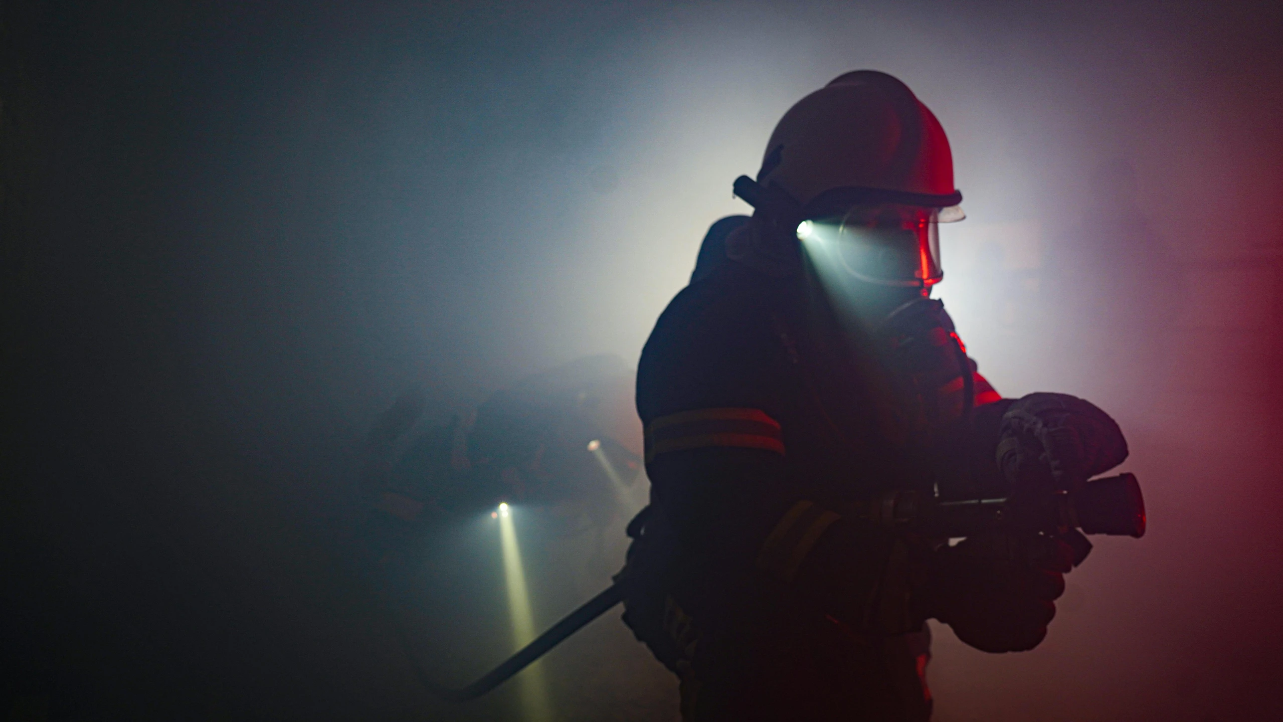 a firefighter standing in front of a red and blue light, pexels, renaissance, foggy light from fires, avatar image, indoor picture, mining