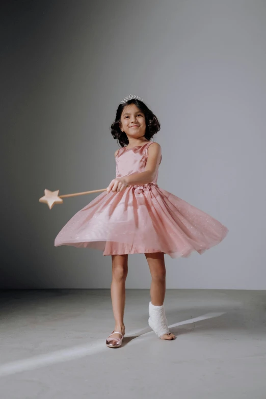 a little girl in a pink dress holding a star wand, production photo, lookbook, f / 2 0, posed