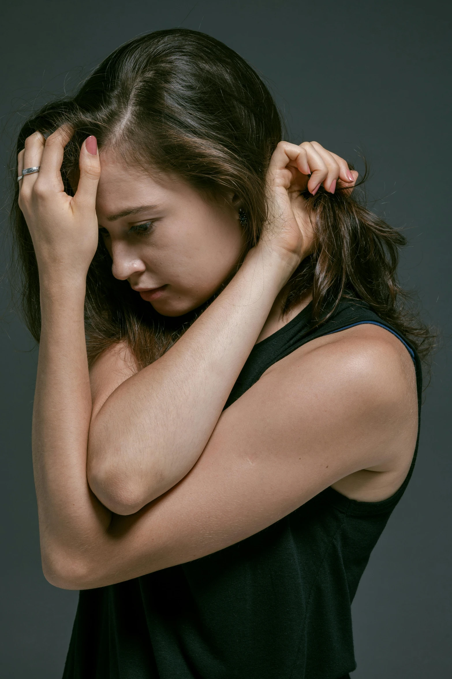 a woman holding her head in her hands, by Adam Marczyński, scratching head, portrait sophie mudd, with a hurt expression, plain background