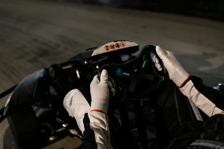 a close up of a person driving a motorcycle, thrustmaster ts pc racer, twintails white_gloves, (night), on set