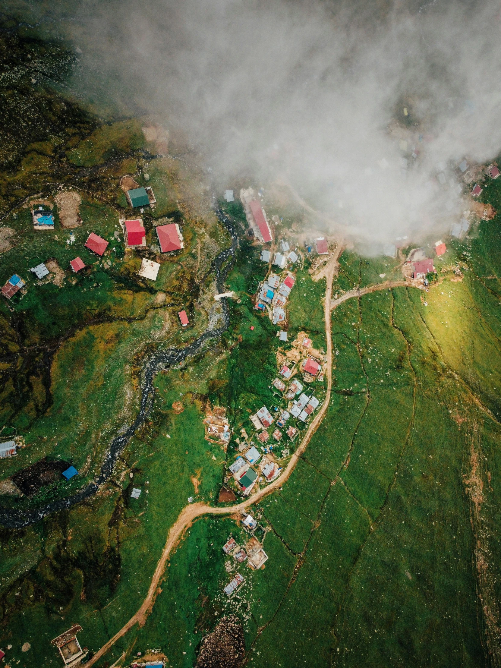 an aerial view of a village in the mountains, pexels contest winner, hurufiyya, rain lit, coloured photo, college, a green