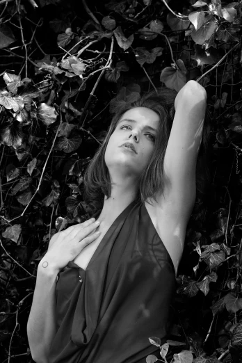 a black and white photo of a woman in a dress, a black and white photo, inspired by Peter Basch, photorealism, emma watson as poison ivy, armpit, !!! colored photography, medium format