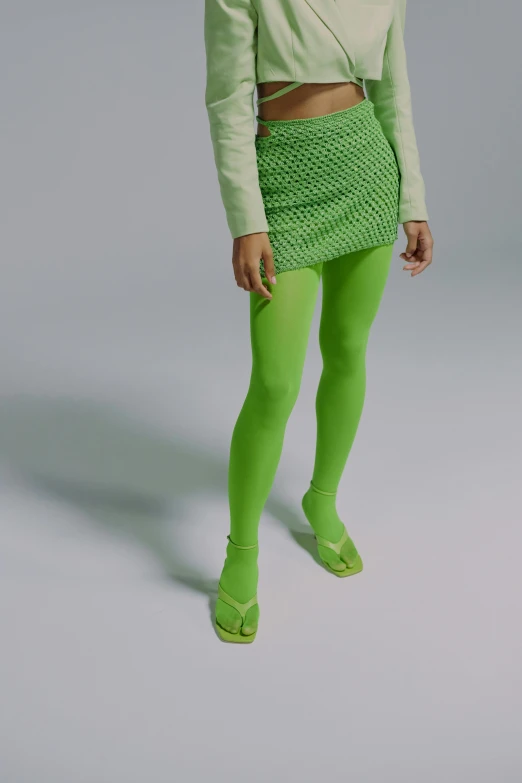 a woman in green tights and a cropped top, wearing a neon green dress, off - white collection, soft scale texture, ((neon colors))