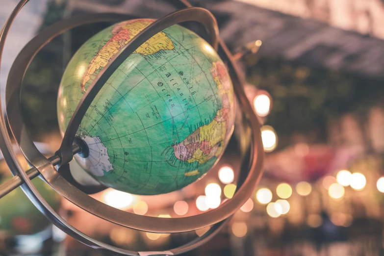 a close up of a globe with lights in the background, 🚿🗝📝, vintage vibe, a green, outher worldly colours