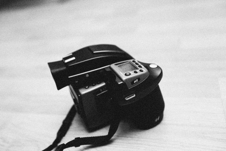 a black and white photo of a camera, by Adam Marczyński, on hasselblaad, very sad c 12.0, mamiya 7 4 3, with back to the camera