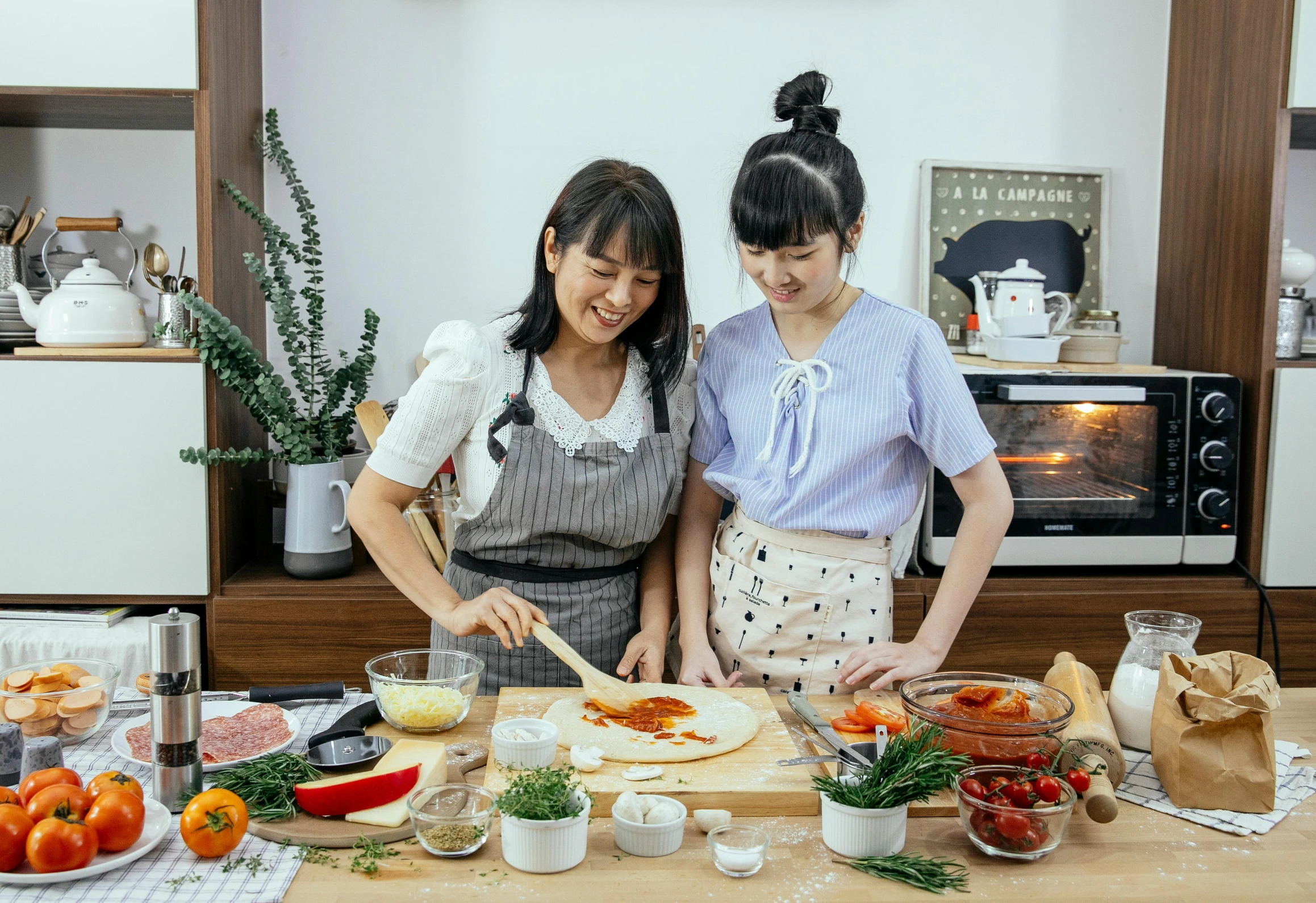 a couple of women standing next to each other in a kitchen, inspired by Yukimasa Ida, pexels contest winner, cooking pizza, avatar image, korean girl, ingredients on the table