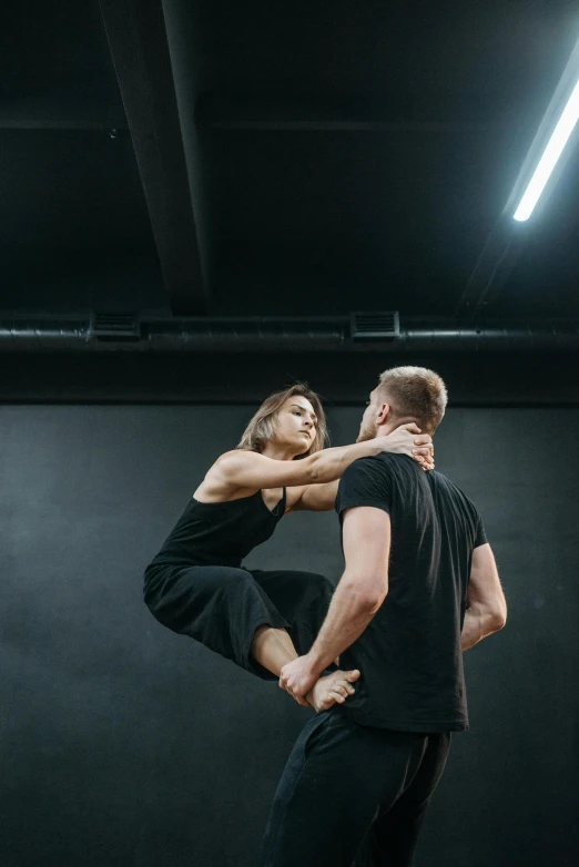 a man and a woman dancing in a dance studio, by Adam Marczyński, pexels contest winner, arabesque, ninja warrior, square, holding close, julian ope