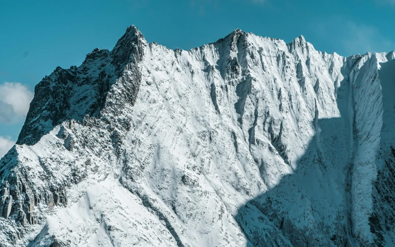 a large mountain covered in snow under a blue sky, by Adam Marczyński, pexels contest winner, hurufiyya, high resolution ultradetailed, craggy, profile picture 1024px, vray 8k