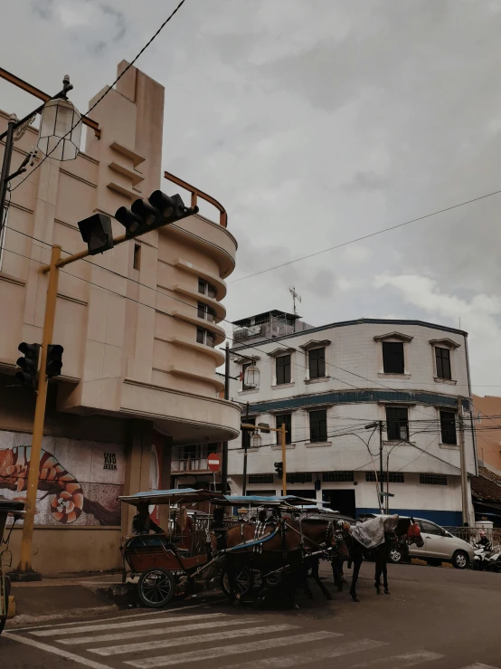 a street filled with lots of traffic next to tall buildings, pexels contest winner, art nouveau, guwahati, with horse driven, 😭 🤮 💕 🎀, an old cinema