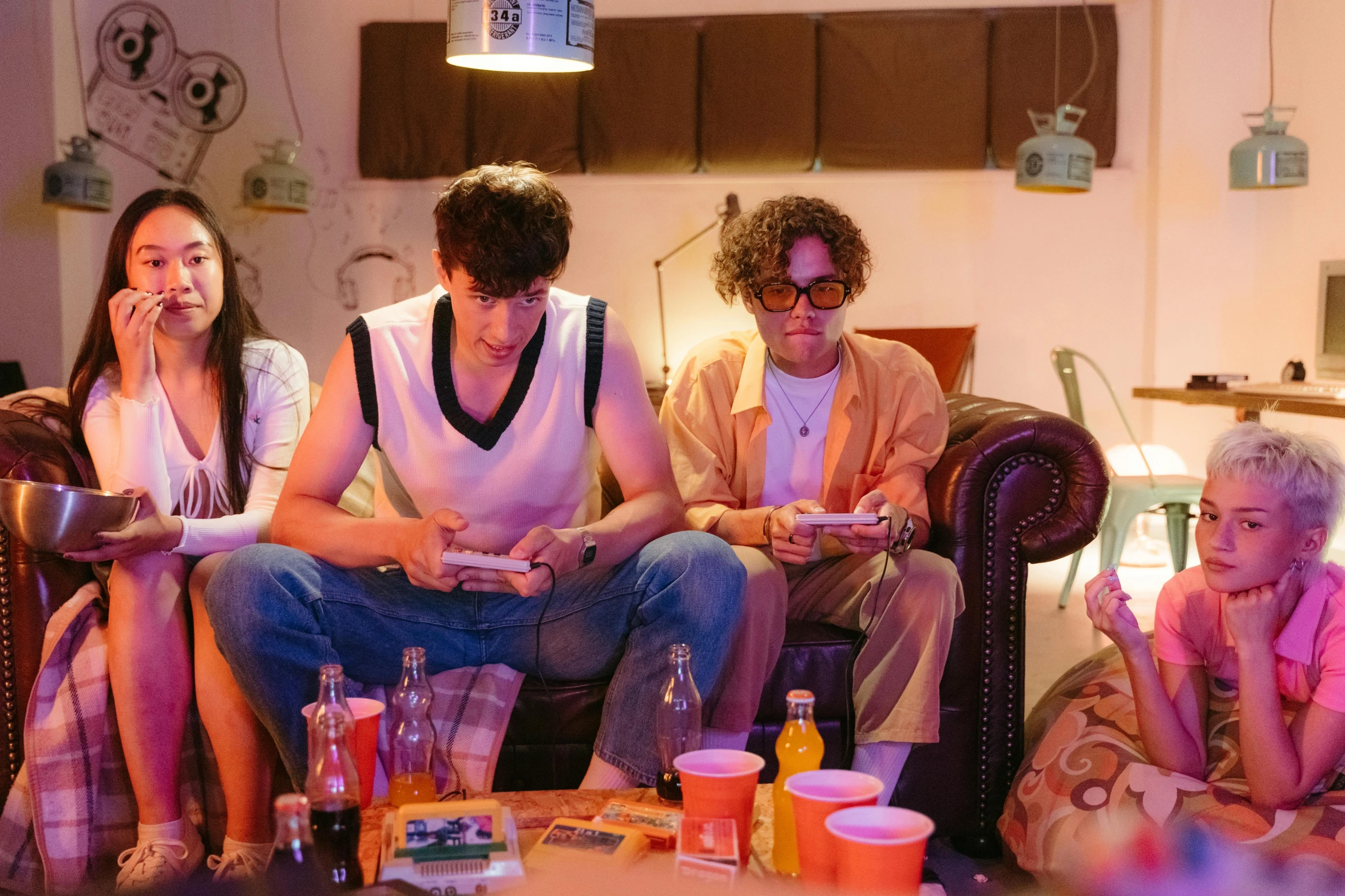 a group of people sitting on top of a couch, an album cover, by Nick Fudge, pexels, serial art, twins playing video games, declan mckenna, scene from a dinner party, arcade