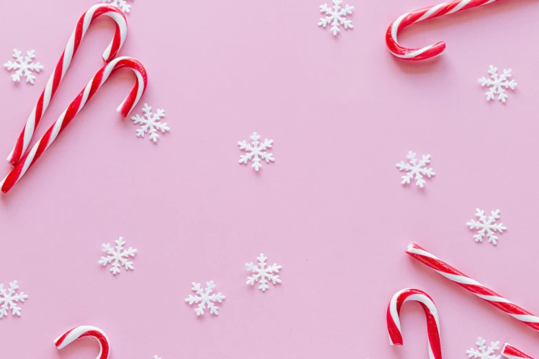 candy canes and snowflakes on a pink background, by Carey Morris, trending on pexels, list, background image, scattered props, aww