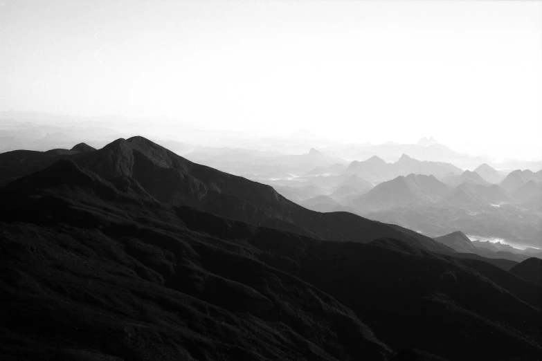 a black and white photo of a mountain range, a black and white photo, by Matthias Weischer, unsplash contest winner, minimalism, early morning mood, view from the top, reunion island landscape, high contrast 8k