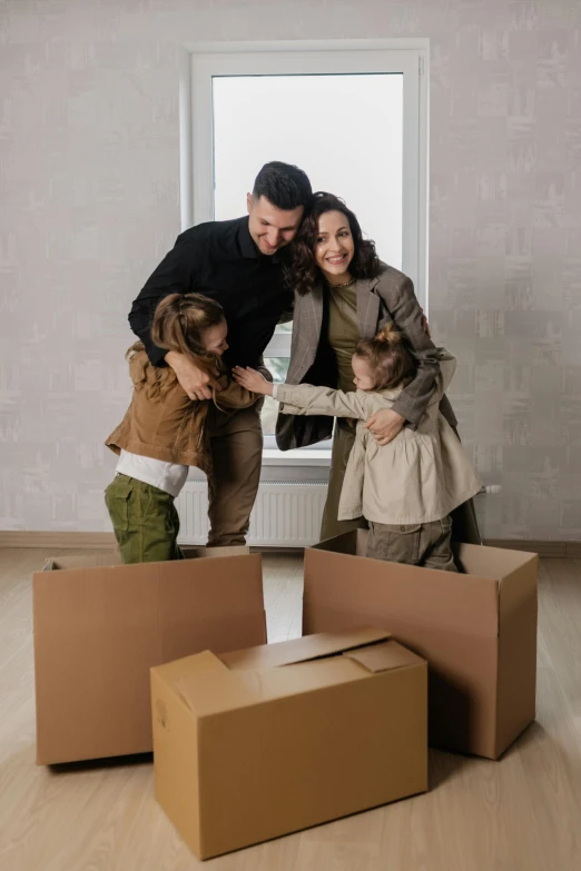 a man and two children standing in a room with boxes, selling insurance, brown, residential, square