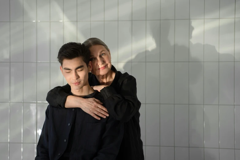 a man and a woman standing next to each other, by Emma Andijewska, photorealism, jin shan and ross tran, mother, in a bathroom, shot in the photo studio