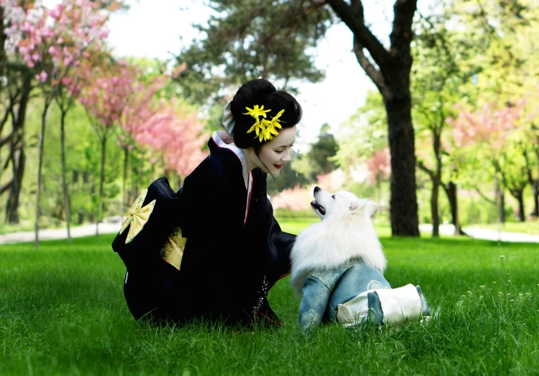 a woman sitting on top of a lush green field next to a white dog, inspired by Nishikawa Sukenobu, unsplash, furry art, high quality costume, with yellow flowers around it, wearing a black noble suit, cosplay photo