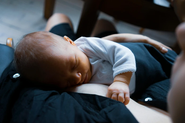 a close up of a person holding a baby, reclining, open belly, best practice, manuka