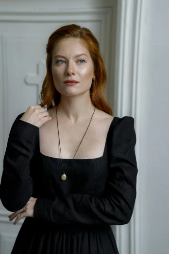 a woman in a black dress posing for a picture, inspired by Júlíana Sveinsdóttir, wearing several pendants, miranda otto, promotional image, profile image