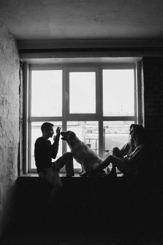 a couple of people sitting on top of a window sill, a black and white photo, by Muggur, let's be friends, egor letov, with dogs, - n 5