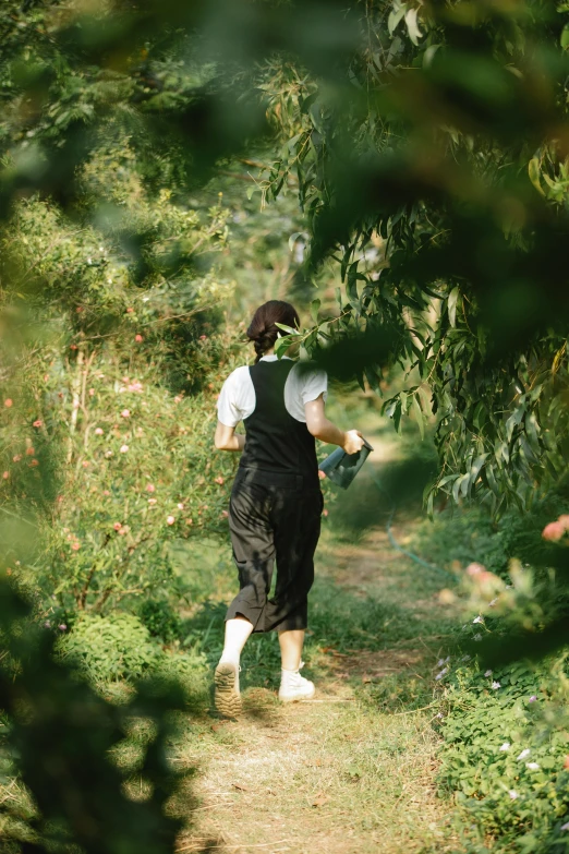 a person walking down a path in the woods, by Shang Xi, happening, gardening, wearing overalls, hidden area, profile image