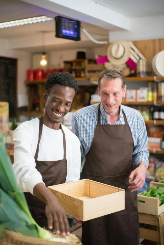 a couple of men standing next to each other in a store, pexels, renaissance, white apron, a wooden, fertile, programming